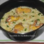 Pilaf cu carne de pasăre servit pe un platou cu garnitură de legume proaspete.